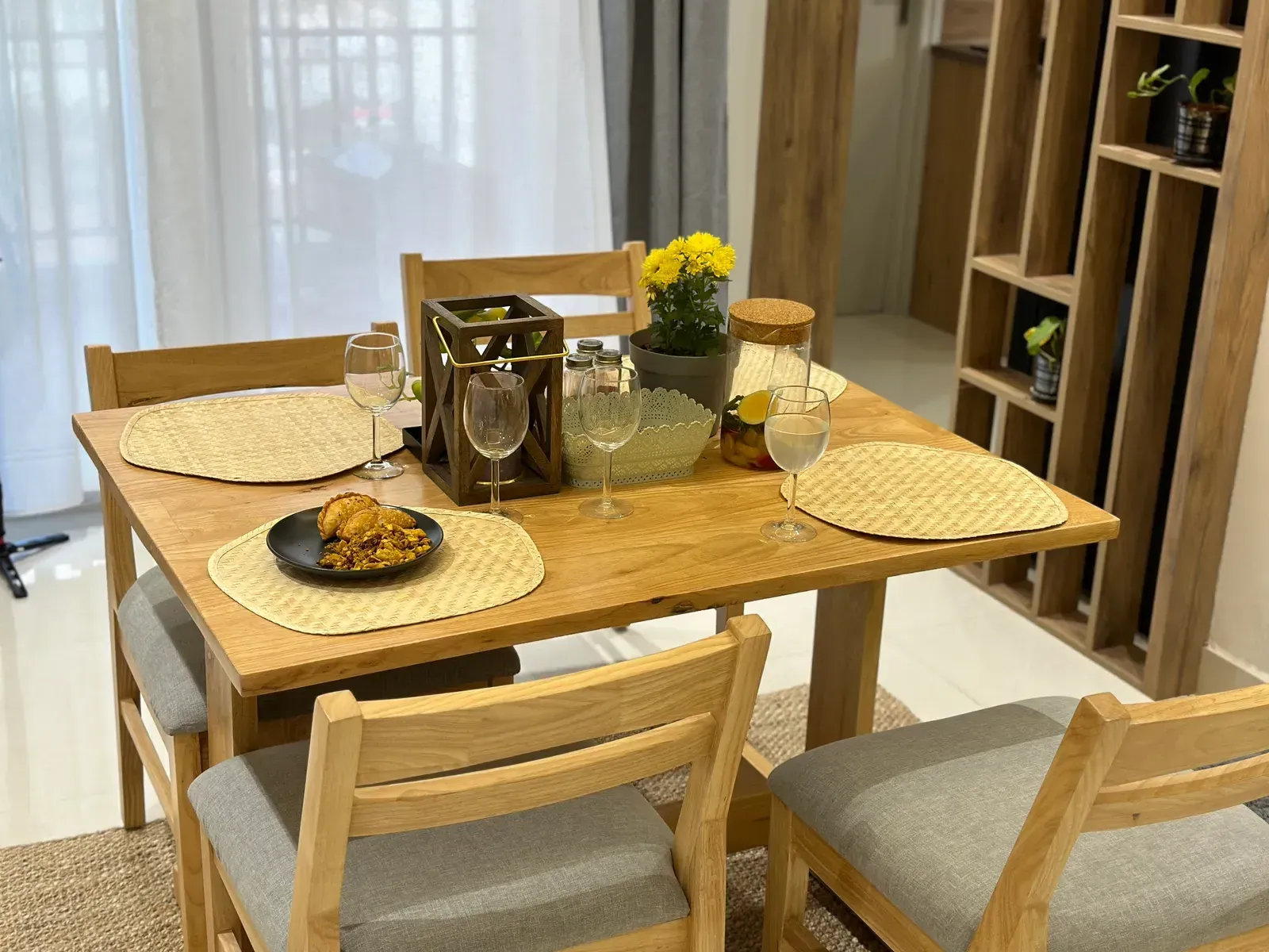 Oak dining table set for a meal — The Aakar